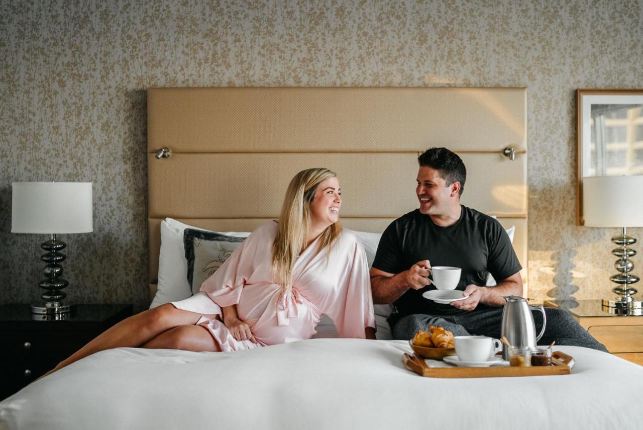 Fairmont Waterfront Hotel Vancouver Exterior photo A couple enjoying room service at the Four Seasons Hotel
