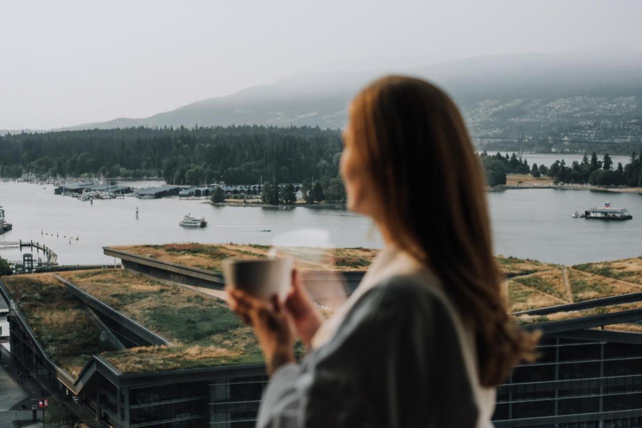 Fairmont Waterfront Hotel Vancouver Exterior photo A woman drinking coffee